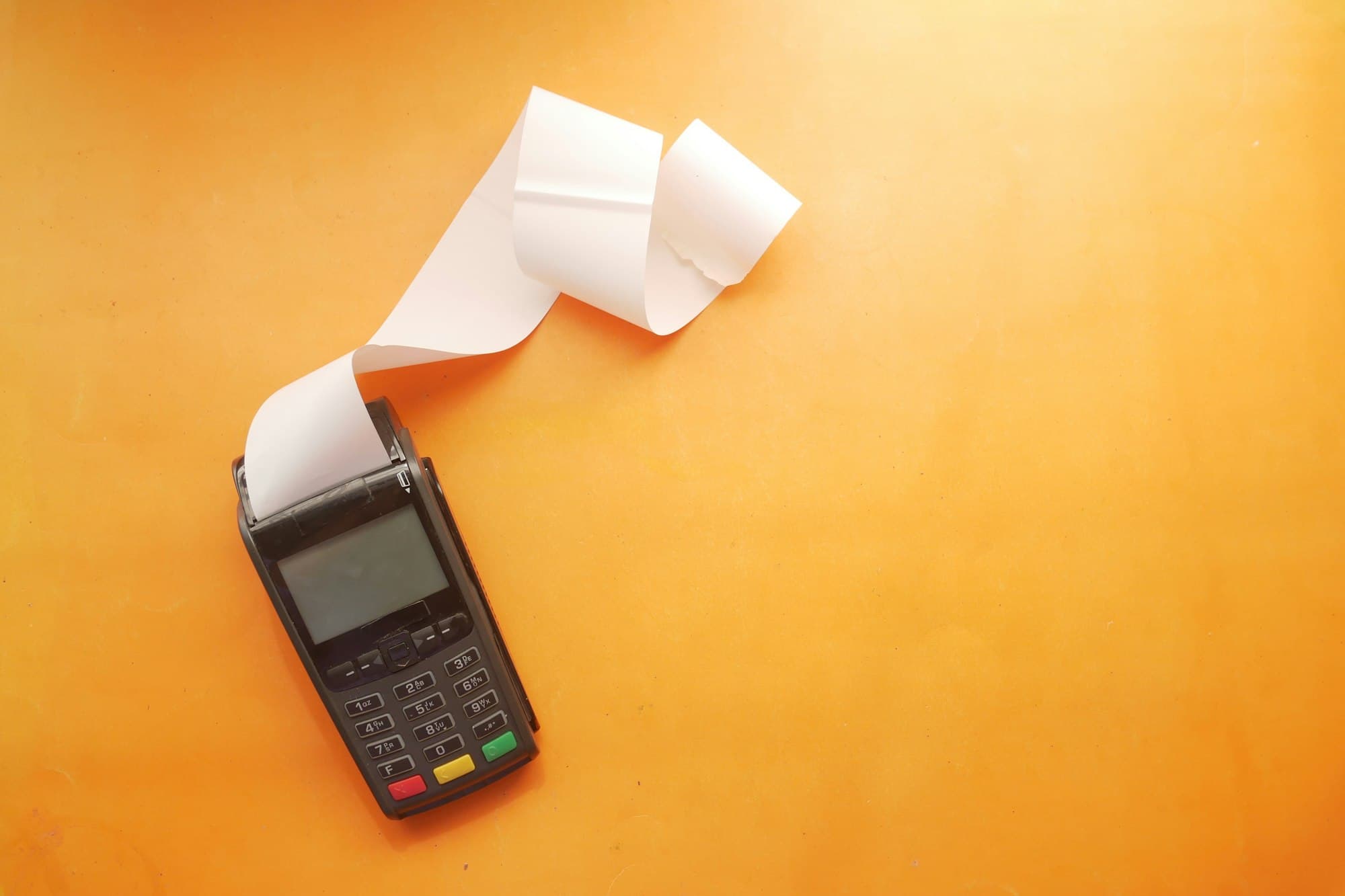 Card payment terminal printing a long paper receipt