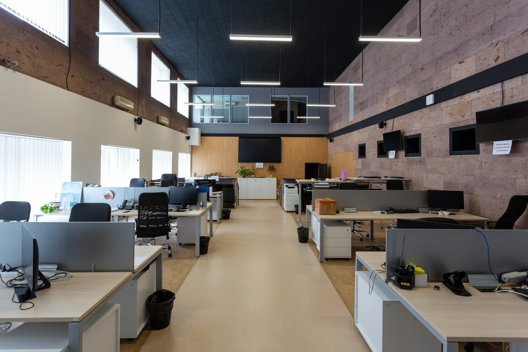 Open-plan finance office with rows of desks and monitors